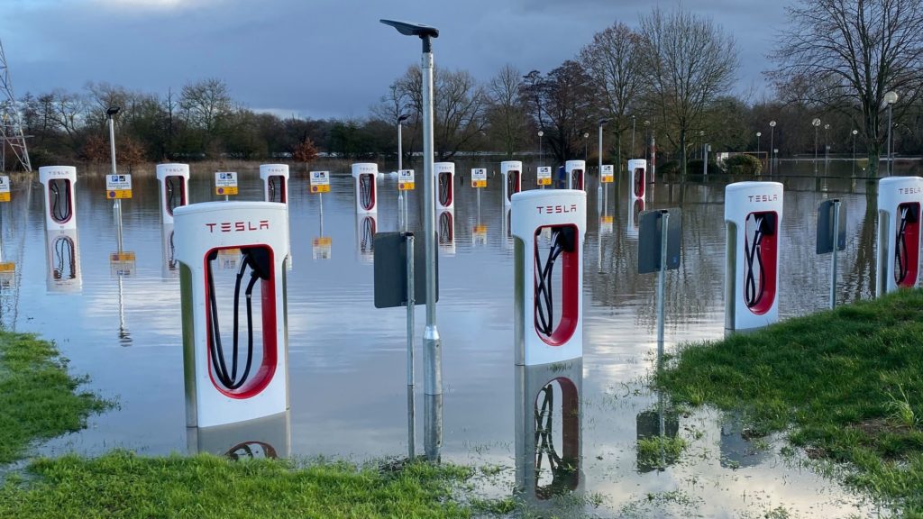 Tesla electrical cahrging stations on flooded ground.